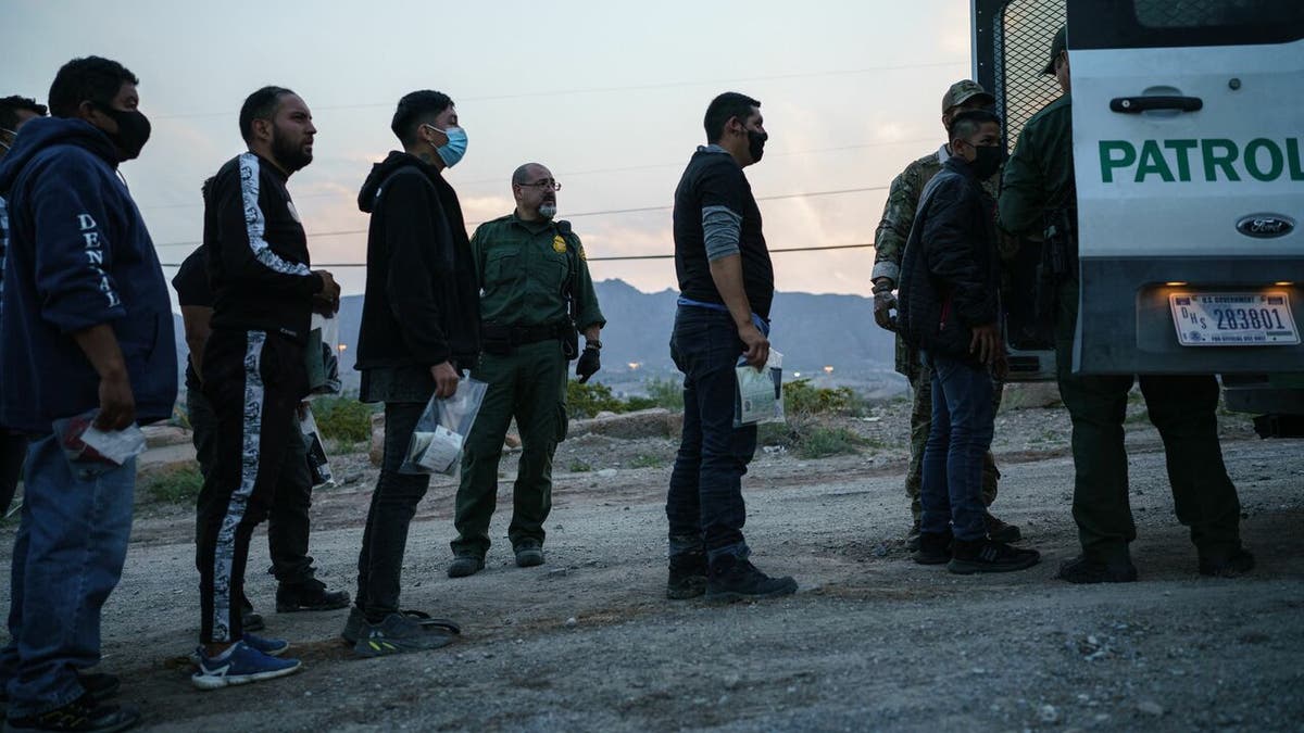 Migrants getting into a truck at the US-Mexico border