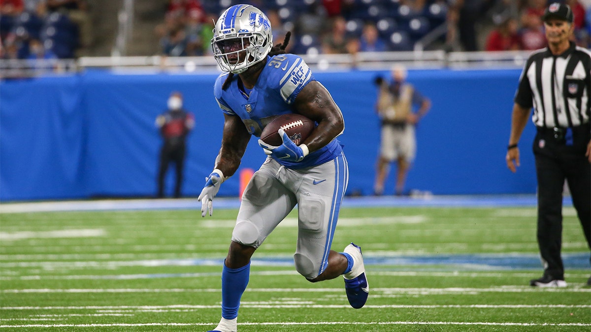 Detroit Lions running back Jamaal Williams (30) runs with the ball during the fourth quarter of a regular season NFL game between the San Francisco 49ers and the Detroit Lions on September 12, 2021 at Ford Field in Detroit, Michigan. 