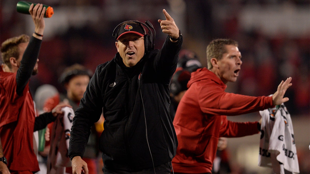 Louisville Cardinals head coach Scott Satterfield points to the big screen as he reacts to a play during the college football game between the Clemson Tigers and the Louisville Cardinals on November 6, 2021, at Cardinal Stadium in Louisville, Kentucky. 