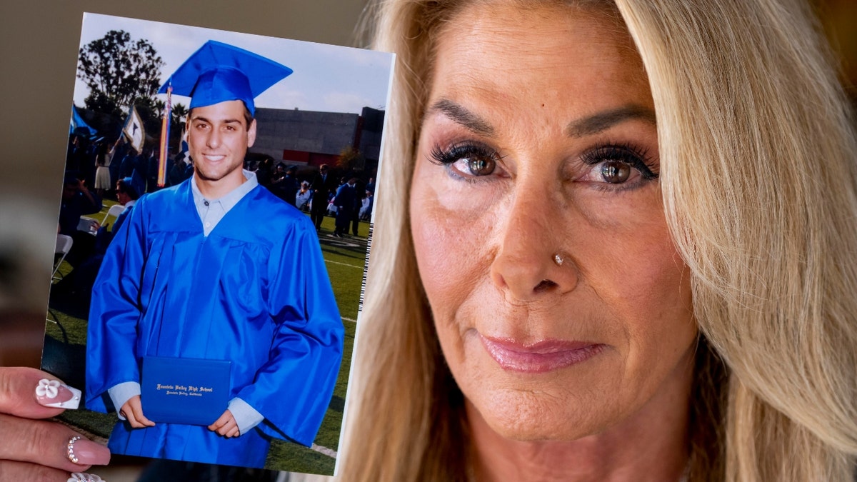 Paula Verrengia is shown at her home in Fountain Valley on Thursday, November 4, 2021 with a photo of her son Sam Doxakis on his graduation from Fountain Valley High. Doxakis died of a fentanyl overdose in March 2018.