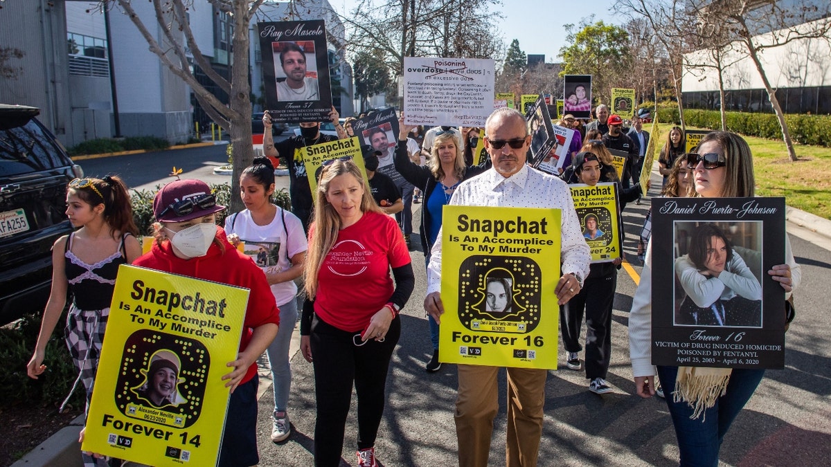 Amy Neville (3rd L) and Jaime Puerta (2nd R) whose children died from fentanyl poisoning protest against illicit drug availability to children on the app Snapchat near the Snap, Inc. headquarters, in Santa Monica, Californiaon January 21, 2022.