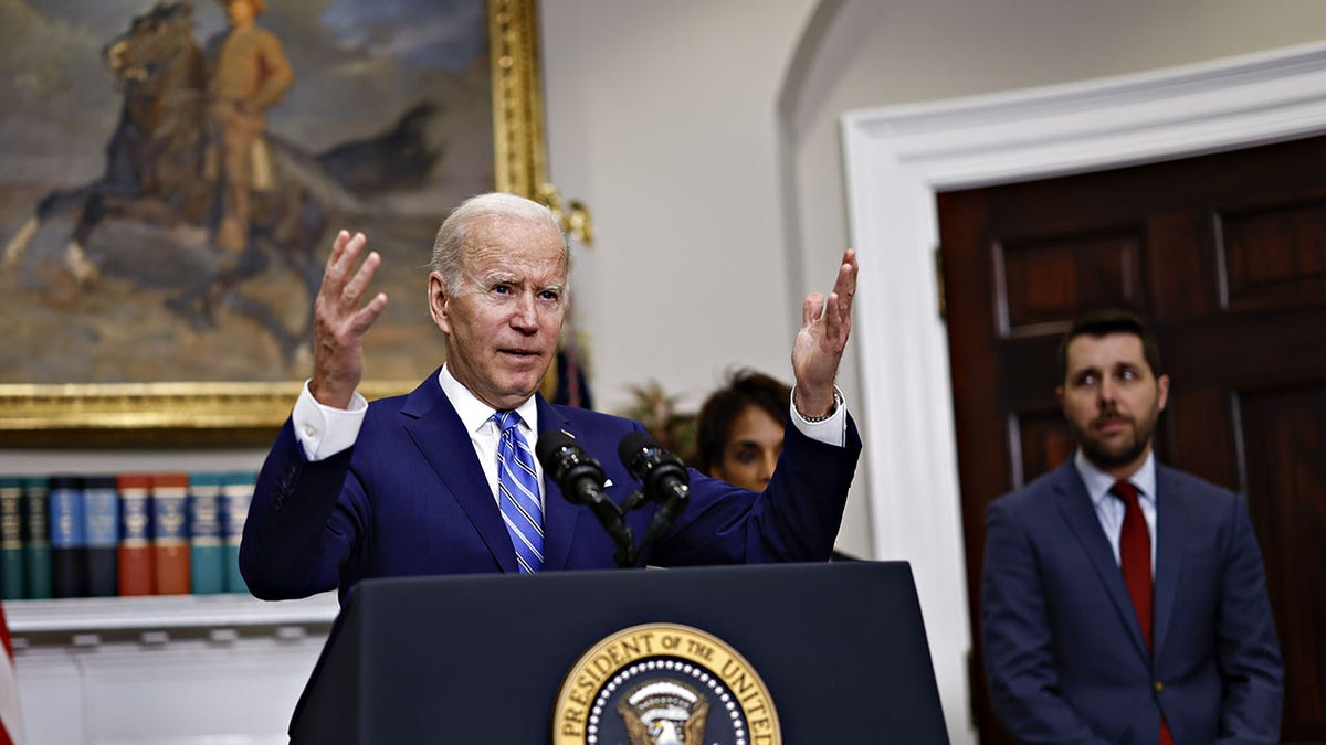 Biden speaks at White House with National Economic Council Director Brian Deese in background