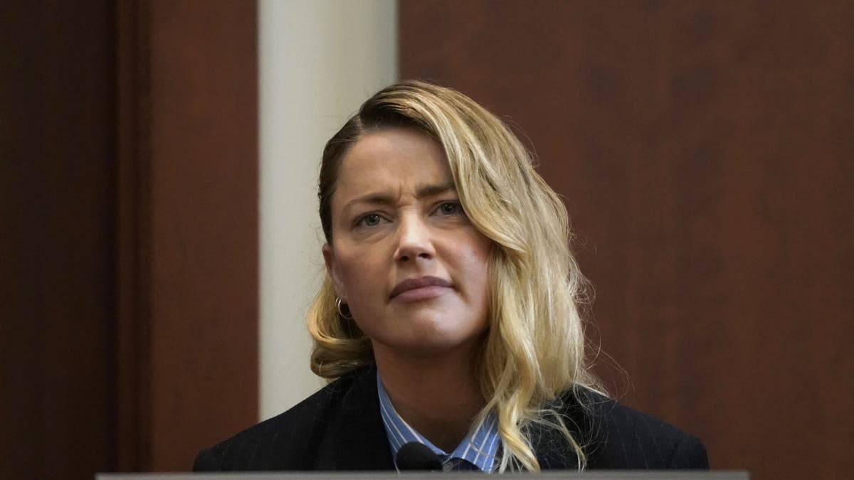 Actor Amber Heard reacts as she testifies at Fairfax County Circuit Court during a defamation case against her by ex-husband, actor Johnny Depp, in Fairfax, Virginia, on May 4, 2022.