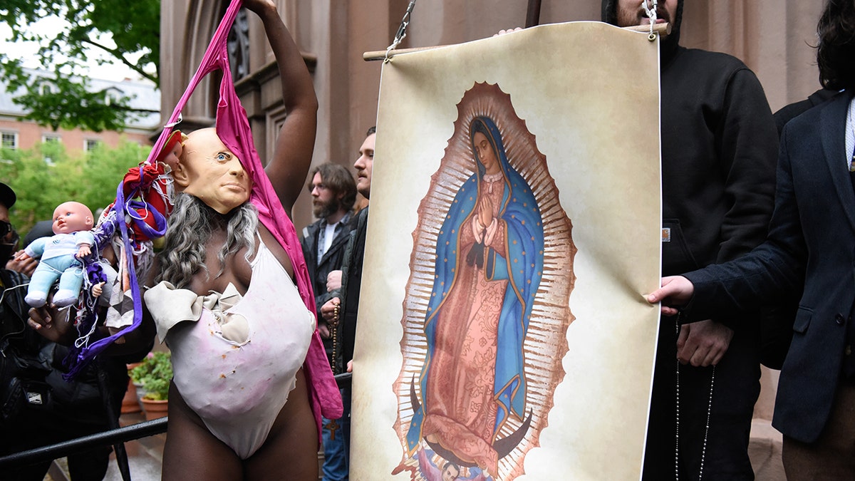 church members are confronted by a pro-choice activist outside of a Catholic church in downtown Manhattan