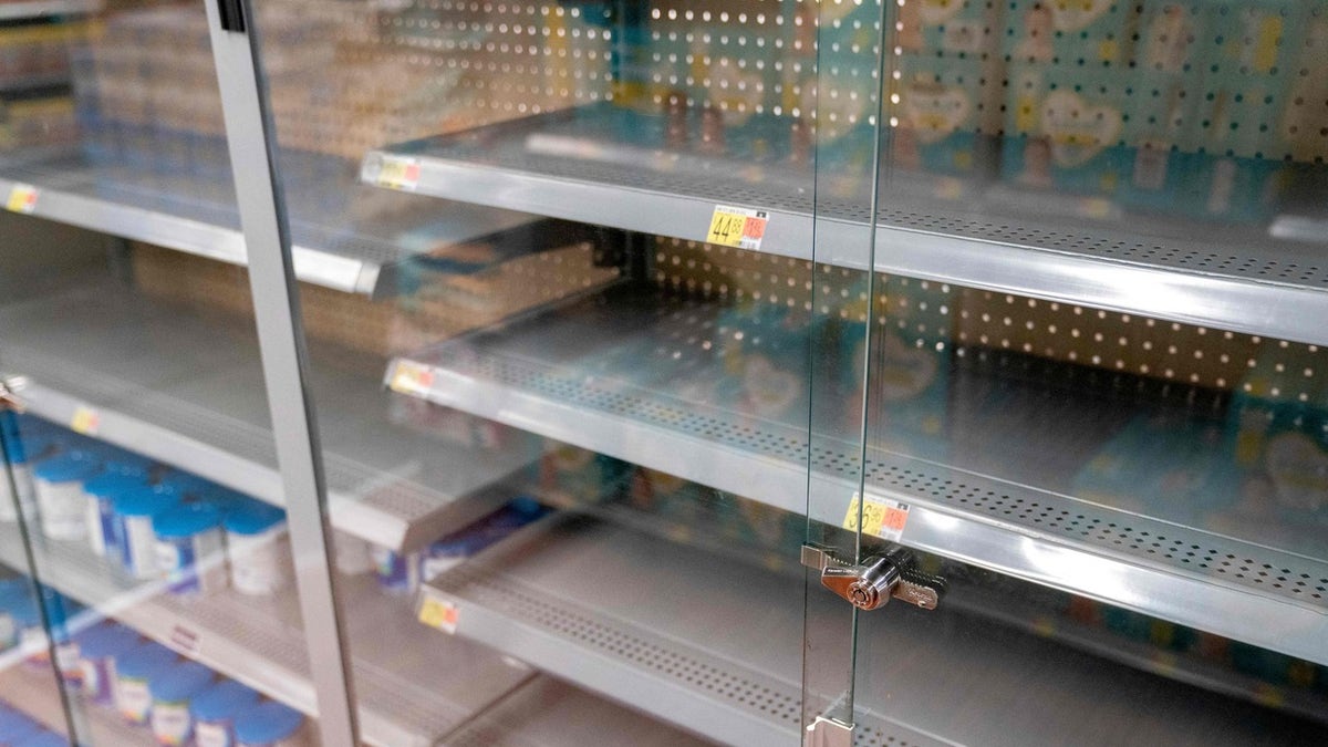 Grocery store shelves where baby formula is typically stocked are locked and nearly empty in Washington, DC, on May 11, 2022. - It's a parent's worst nightmare.