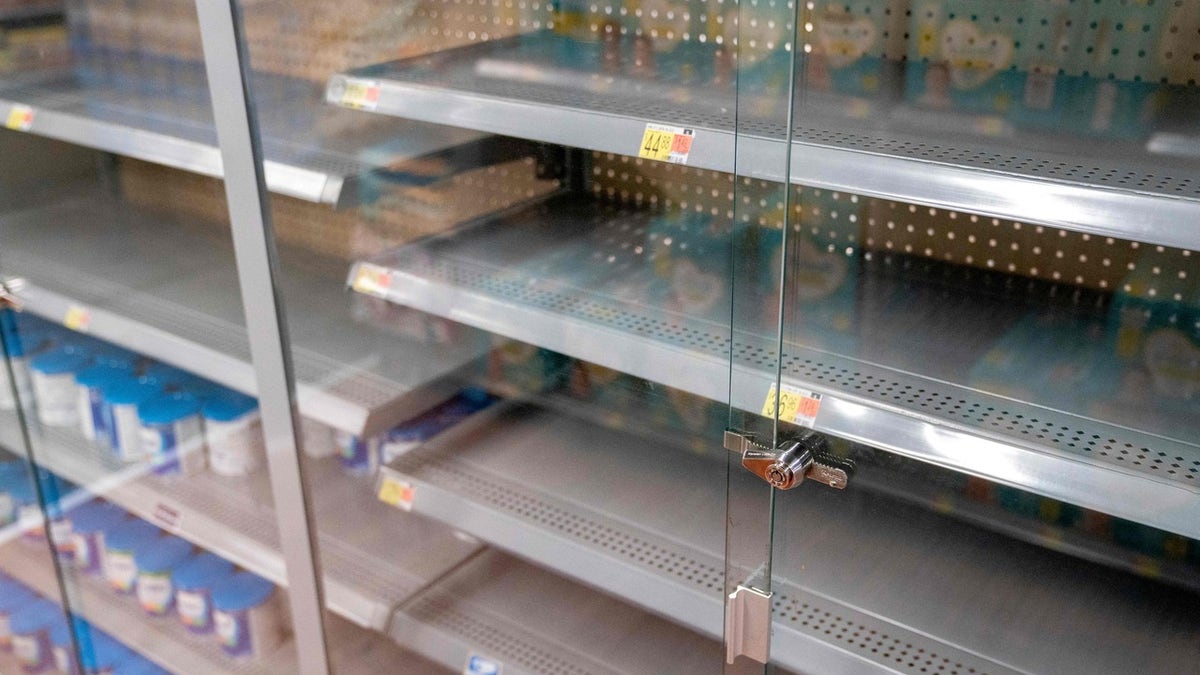 Grocery store shelves where baby formula is typically stocked are locked and nearly empty in Washington, DC, on May 11, 2022. - It's a parent's worst nightmare.