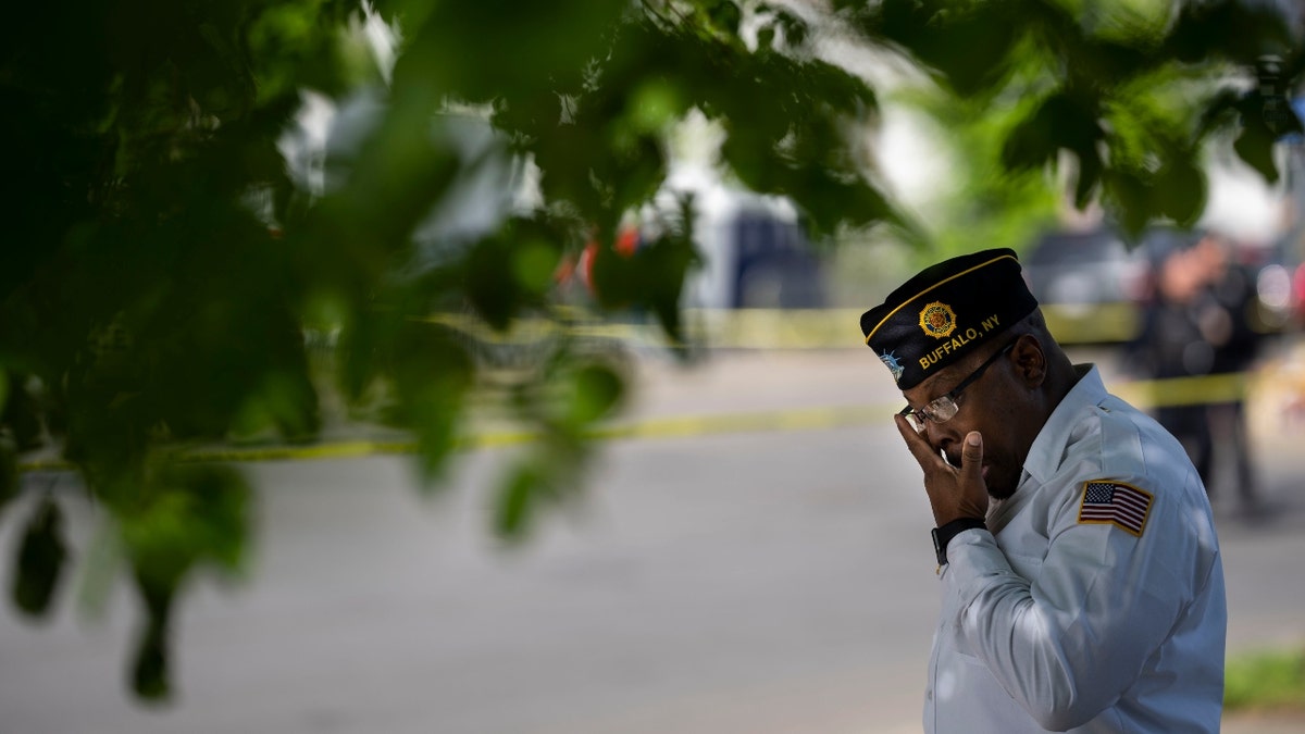 Howard Patton pays his respects at a makeshift memorial across the street from Tops Friendly Market at Jefferson Avenue and Riley Street on Wednesday, May 18, 2022 in Buffalo, NY.