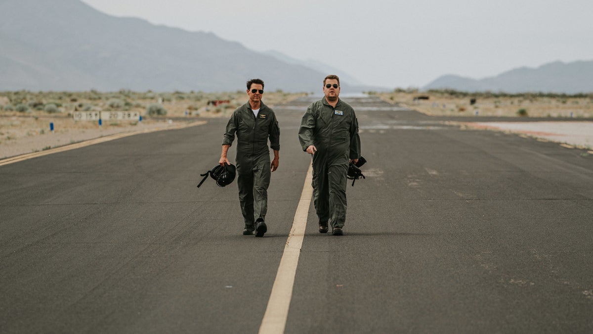 James Corden and Tom Cruise walk the runway before flying.