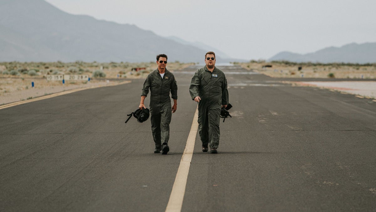 James Corden and Tom Cruise walk the runway before flying.