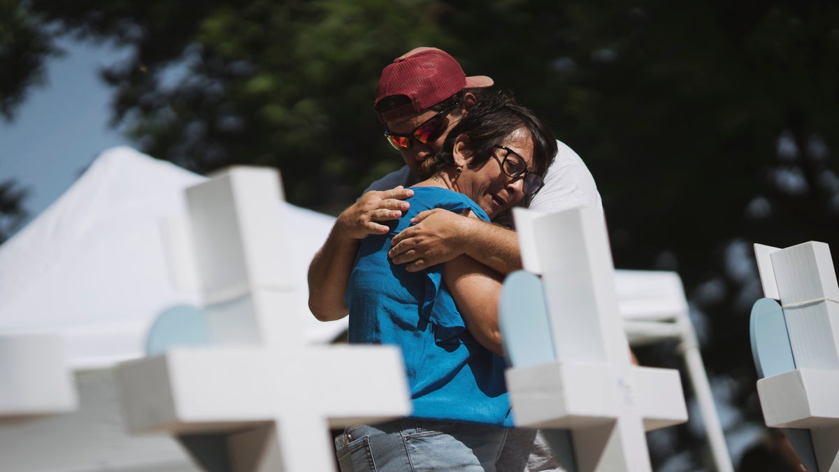 Couple embraces at the memorial for school shooting victims