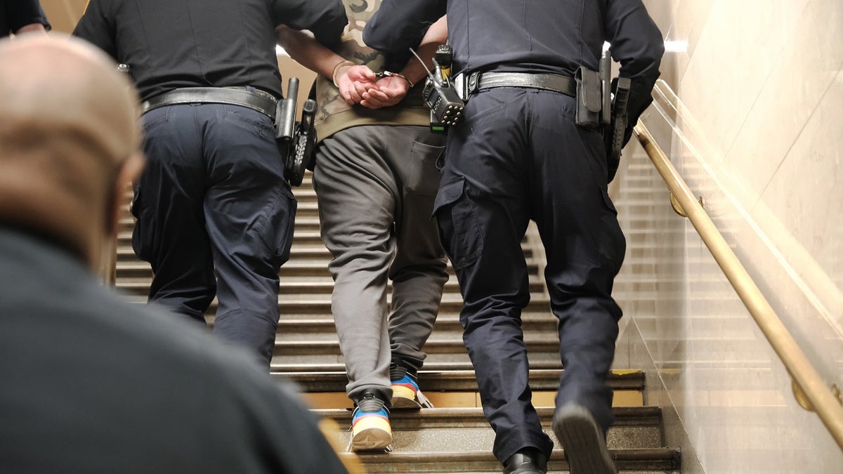 Police detain a man at a Times Square subway station following a call to police from riders on April 25, 2022 in New York City.