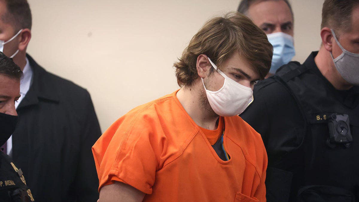 Payton Gendron wears orange jumpsuit as officers escort him into courtroom