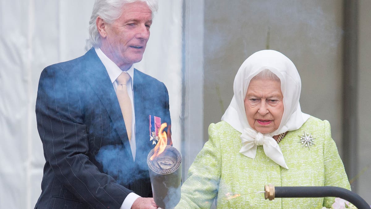 Bruno Peek helps Queen Elizabeth light a beacon