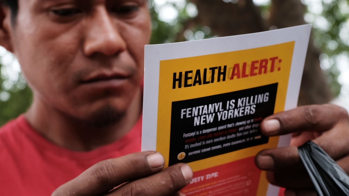 A man reads an alert on fentanyl before being interviewed by John Jay College of Criminal Justice students as part of a project to interview Bronx drug users in order to compile data about overdoses on August 8, 2017 in New York City.