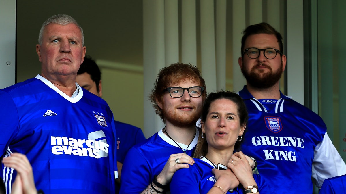 Ed Sheeran and Cherry Seaborn watching a football game in England