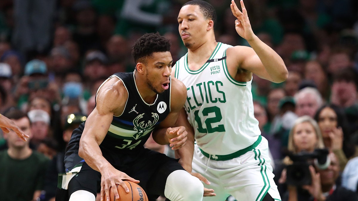 Grant Williams #12 of the Boston Celtics defends Giannis Antetokounmpo #34 of the Milwaukee Bucks during the first quarter in Game Seven of the 2022 NBA Playoffs Eastern Conference Semifinals at TD Garden on May 15, 2022 in Boston, Massachusetts. 
