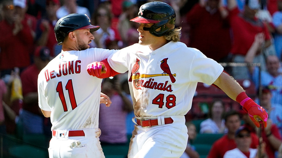 St. Louis Cardinals' Harrison Bader (48) is congratulated by teammate Paul DeJong (11) after hitting a two-run home run during the seventh inning of a baseball game against the Arizona Diamondbacks Sunday, May 1, 2022, in St. Louis.