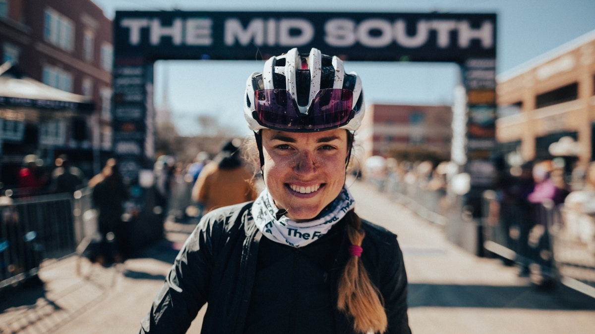 Mo Wilson smiles in racing gear after a race