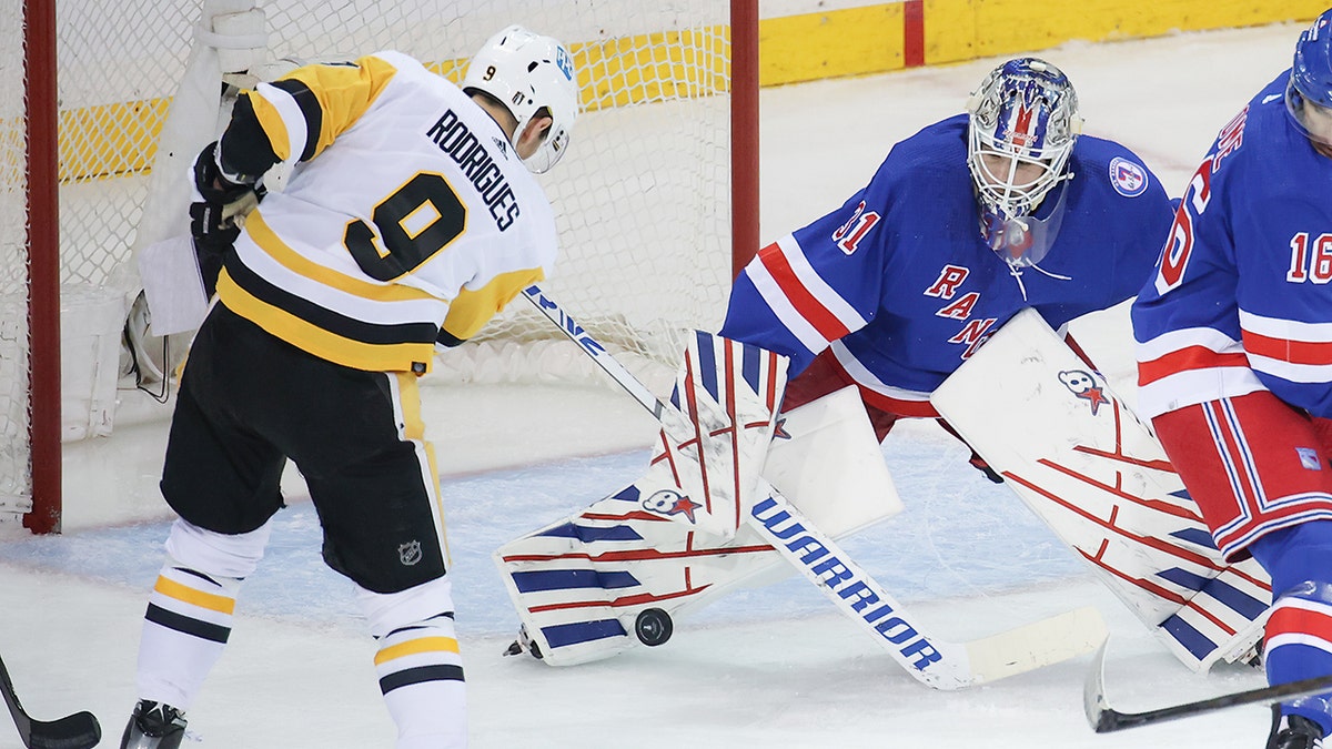 New York Rangers Goaltender Igor Shesterkin (31) makes a save on a shot by Pittsburgh Penguins Right Wing Evan Rodrigues (9) during game 7 of the first round of the NHL Stanley Cup Playoffs between the Pittsburgh Penguins and the New York Rangers on May 15, 2022 at Madison Square Garden in New York, NY.