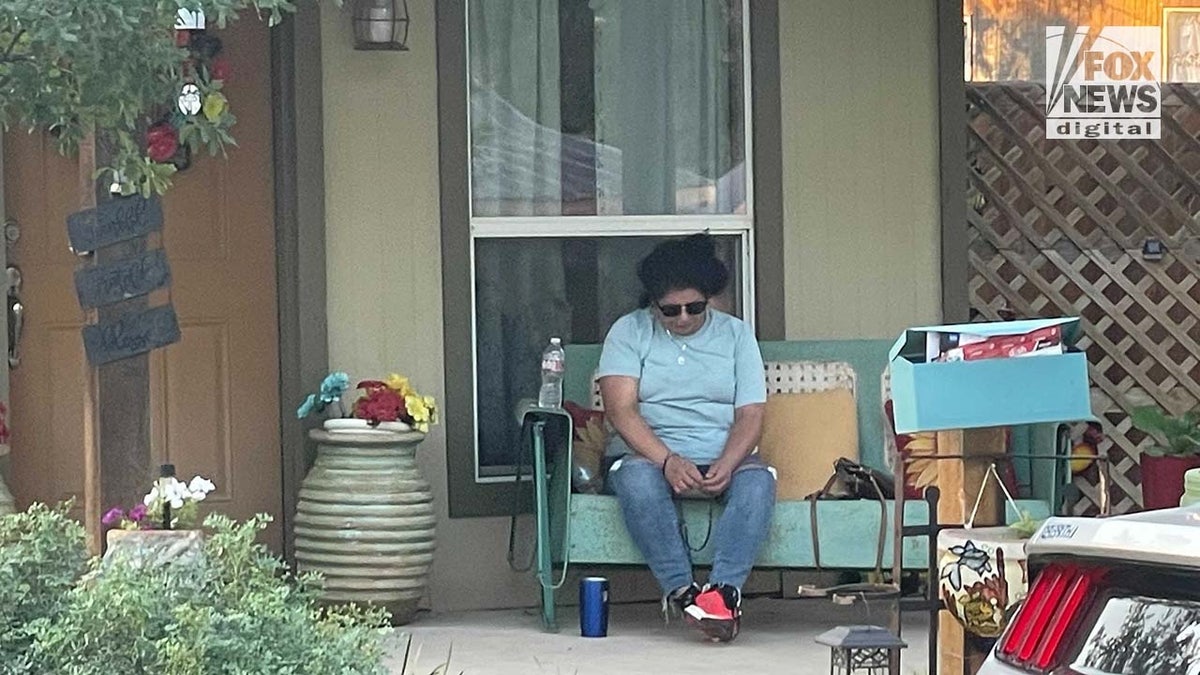 Woman sits outside home in Uvalde, Texas