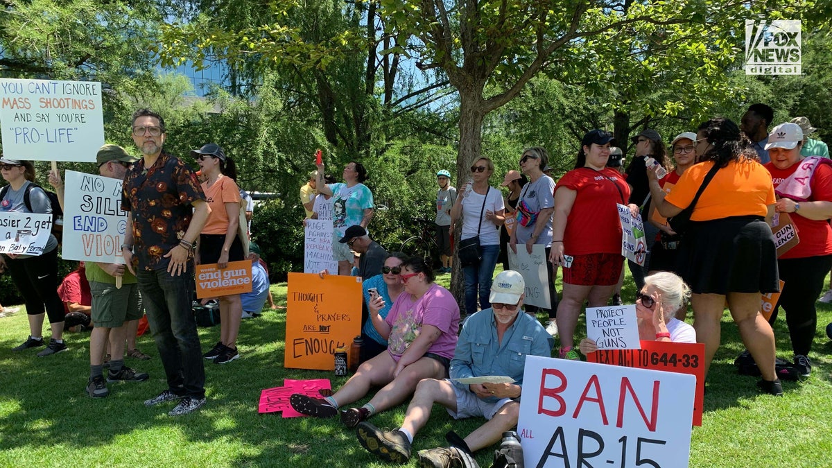 A group sits outside the NRA convention protesting guns