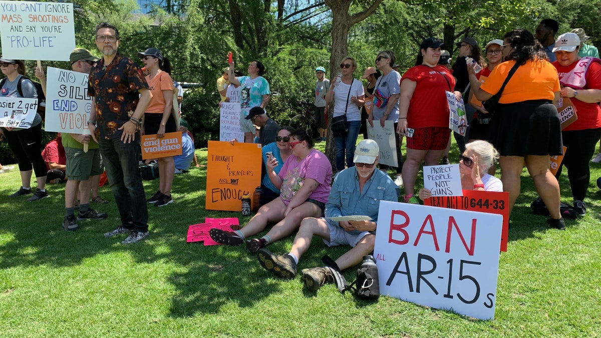 A group sits outside the NRA convention protesting guns