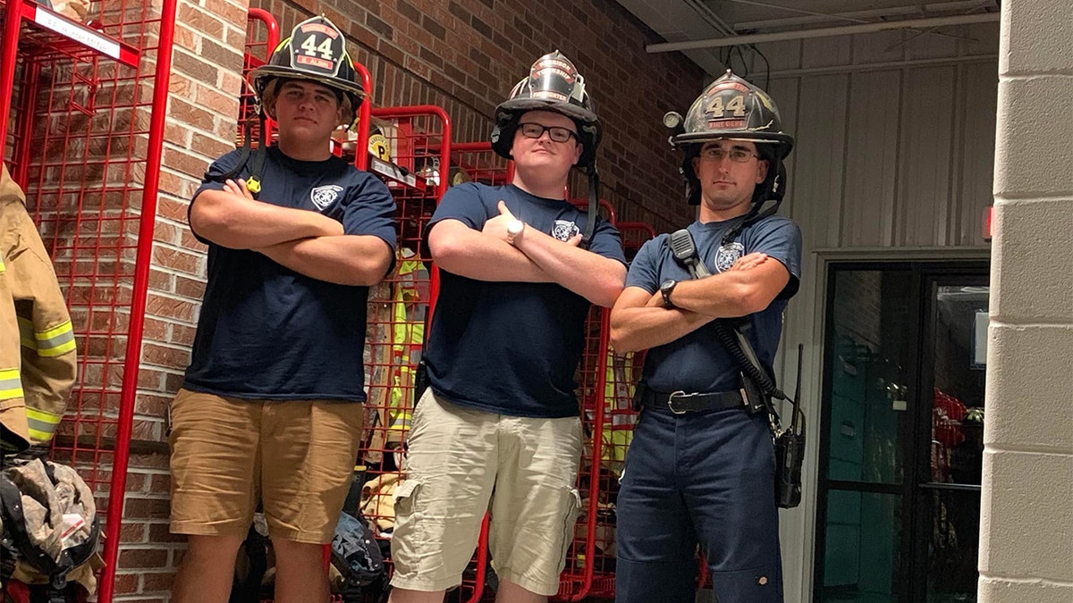 Indiana volunteer firefighter Jacob McClanahan with two other firefighters