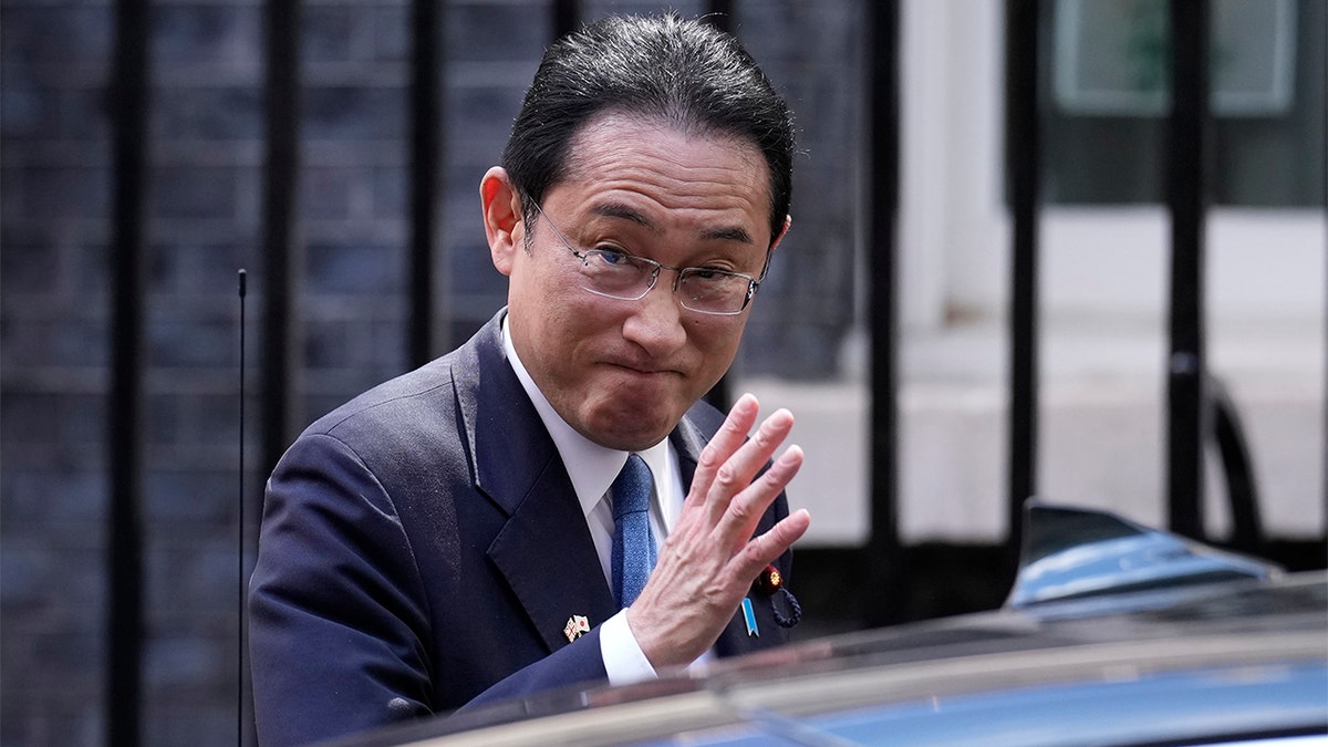 Japanese Prime Minister Fumio Kishida waves at the media as he leaves after his meeting with British Prime Minister Boris Johnson, at 10 Downing Street in London, Thursday, May 5, 2022. (AP Photo/Matt Dunham)