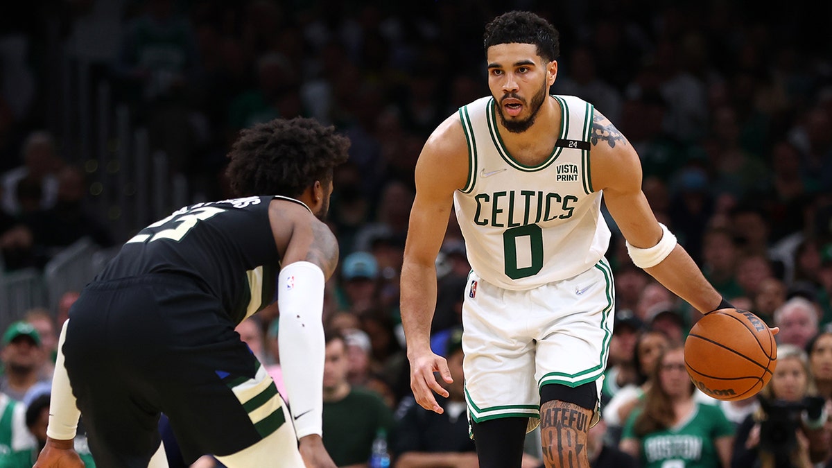 Jayson Tatum #0 of the Boston Celtics dribbles against Wesley Matthews #23 of the Milwaukee Bucks during the second quarter in Game Seven of the 2022 NBA Playoffs Eastern Conference Semifinals at TD Garden on May 15, 2022 in Boston, Massachusetts.