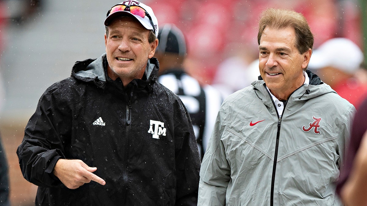 Jimbo Fisher and Nick Saban stand next to each other