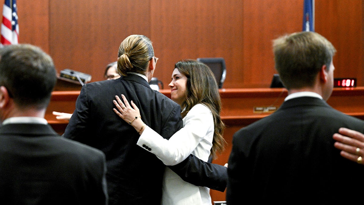 Camille Vasquez hugs Johnny Depp