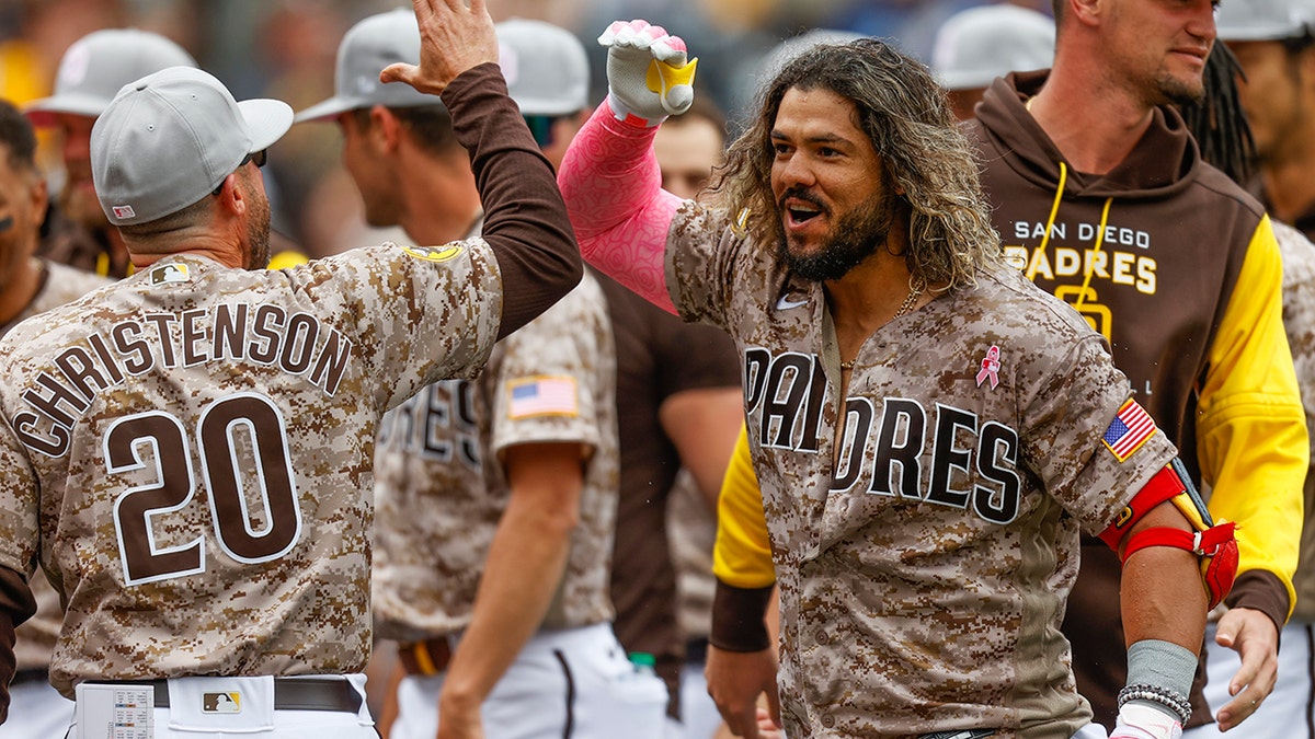 San Diego Padres' Jorge Alfaro, front right, celebrates with bench coach Ryan Christenson after hitting a three-run walkoff home run against the Miami Marlins during the ninth inning of a baseball game Sunday, May 8, 2022, in San Diego.?