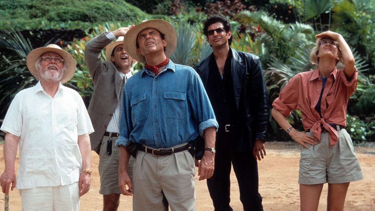 The cast of "Jurassic Park" looks up while filming a scene on the dinosaur island