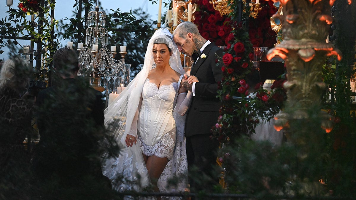 Kourtney Kardashian wore a white lace mini dress with a cathedral length veil at Italian wedding