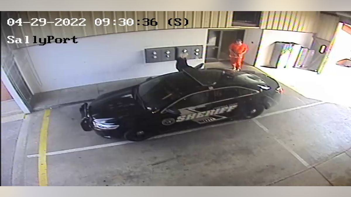 Surveillance video appears to show missing Alabama corrections officer Vicky White leaving the Lauderdale County Detention Center Friday morning with the fugitive suspected murderer Casey Cole White walking behind her in leg shackles and handcuffs.