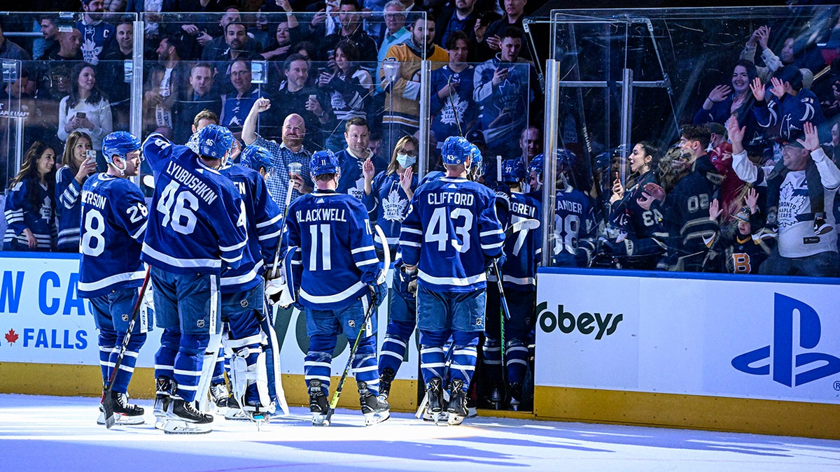 Toronto Maple Leafs fans cheer on the team as they exit the ice after defeating the Boston Bruins in an NHL hockey game in Toronto, Friday, April 29, 2022. 
