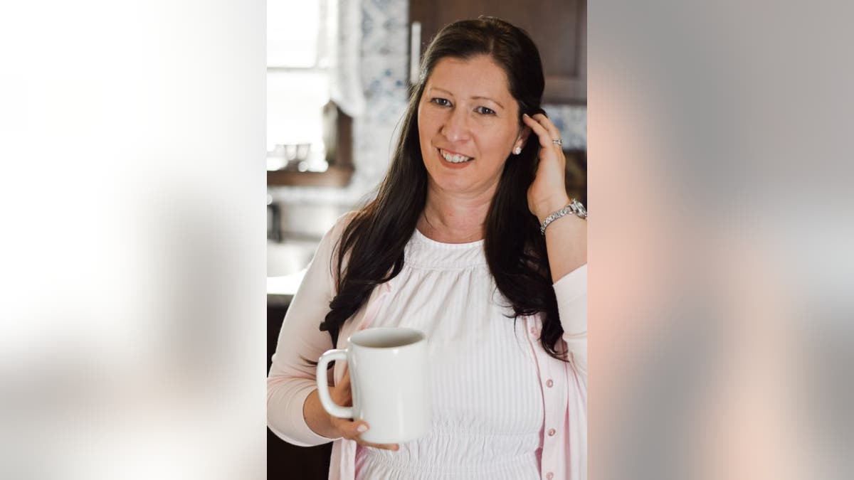 Mary Wolta poses with coffee mug