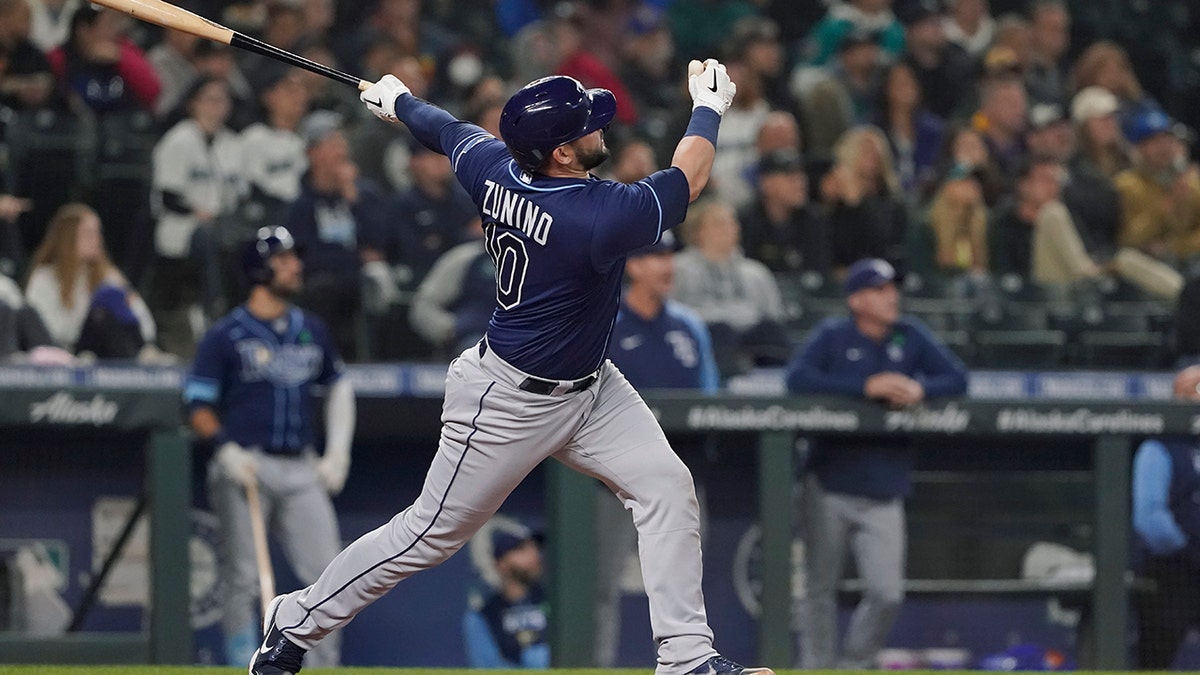 Tampa Bay Rays' Mike Zunino follows through on a three-run home run during the fourth inning of the team's baseball game against the Seattle Mariners, Thursday, May 5, 2022, in Seattle.