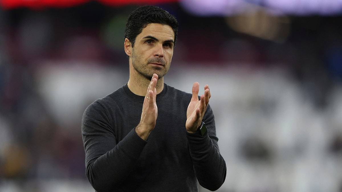 Arsenal's manager Mikel Arteta applauds his teams fans after the end of the English Premier League soccer match between West Ham United and Arsenal at the London stadium in London, Sunday, May 1, 2022. Arsenal win the game 2-1. 
