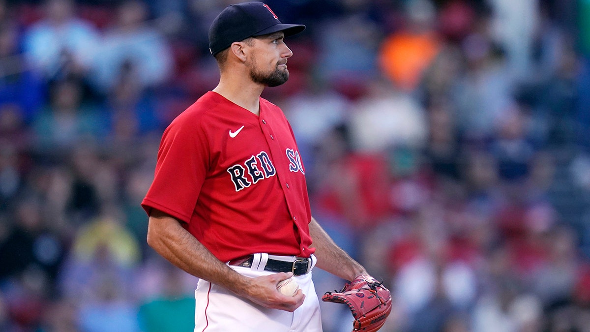 Boston Red Sox starting pitcher Nathan Eovaldi looks toward the outfield while holding a new baseball after a home run by Houston Astros' Yordan Alvarez during the second inning of a baseball game at Fenway Park, Tuesday, May 17, 2022, in Boston. Eovaldi gave up five home runs in the second inning.?