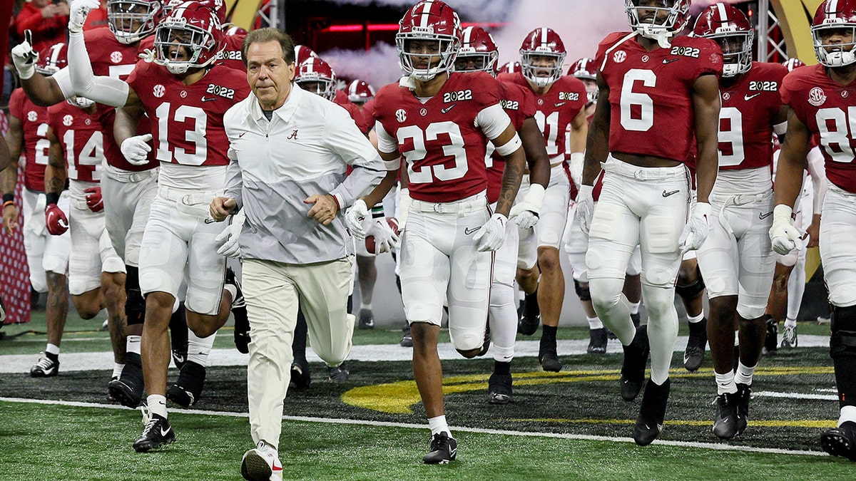 Nick Saban runs onto to the field for the 2022 CFP National Championship