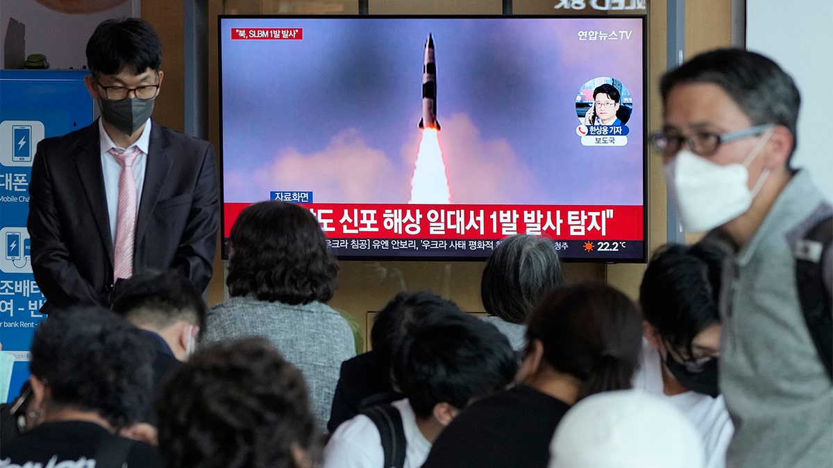 FILE - People watch a TV showing a file image of North Korea's missile launch during a news program at the Seoul Railway Station in Seoul, South Korea, Saturday, May 7, 2022. (AP Photo/Ahn Young-joon)