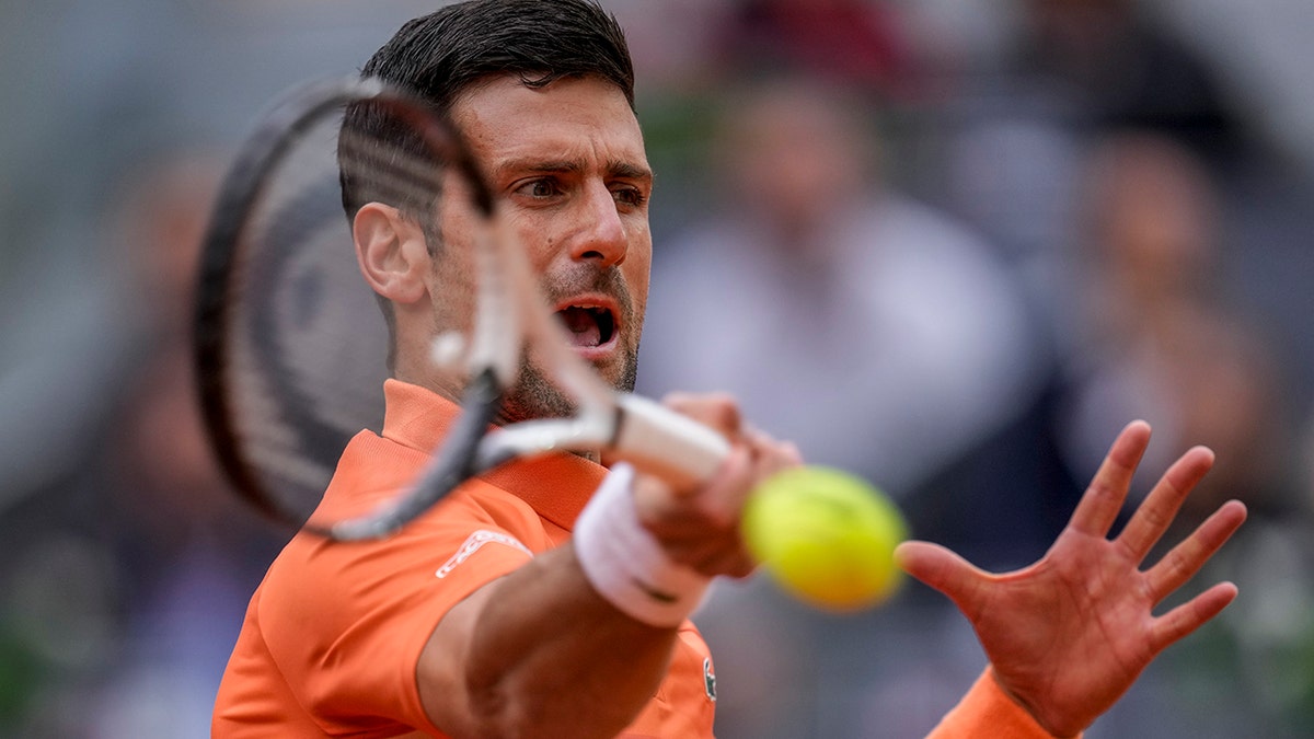 Serbia's Novak Djokovic returns the ball against Gael Monfils, of France, during their match at the Mutua Madrid Open tennis tournament in Madrid, Spain, Tuesday, May 3, 2022.