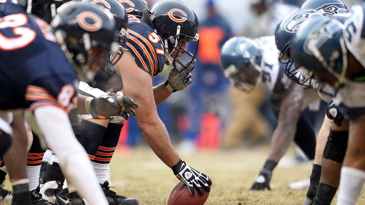 Center Olin Kreutz #57 of the Chicago Bears prepares to snap the ball against the Seattle Seahawks in the first half in the 2011 NFC divisional playoff game at Soldier Field on January 16, 2011 in Chicago, Illinois.