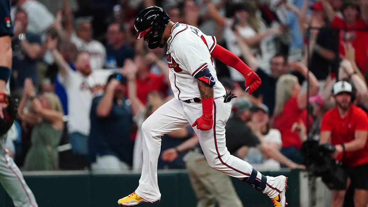 Atlanta Braves' Orlando Arcia reacts as he rounds the bases after hitting a two-run walkout home run in the ninth inning of a baseball game against the Boston Red Sox Wednesday, May 11, 2022, in Atlanta.