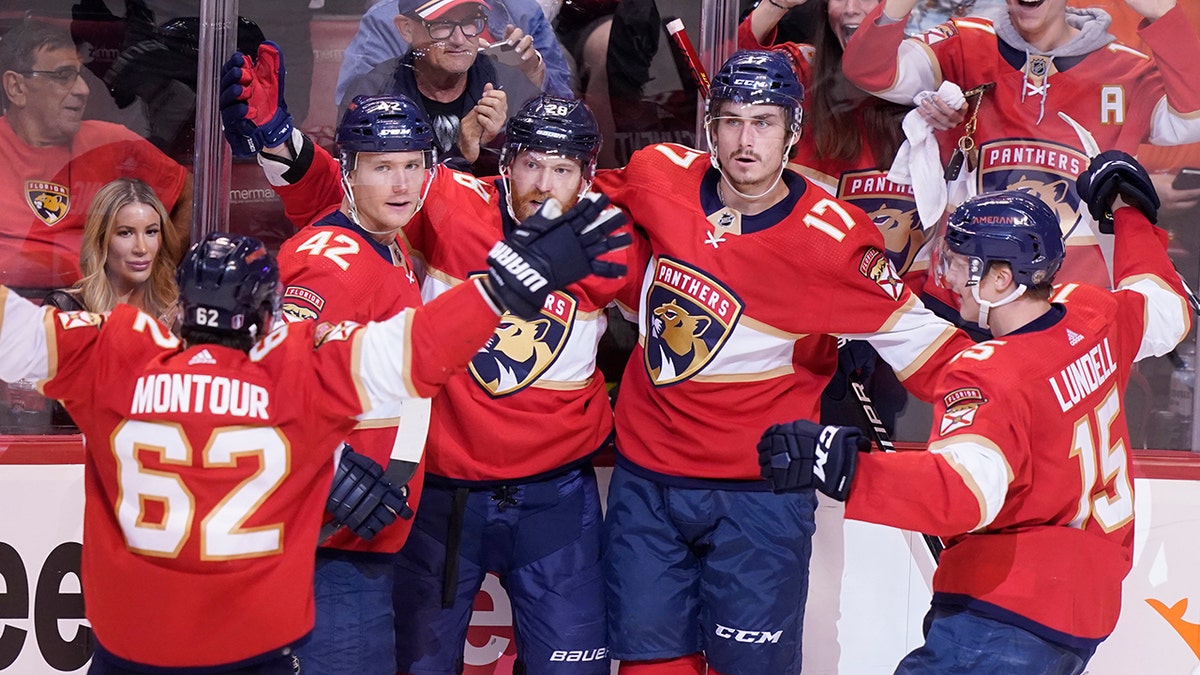 Florida Panthers teammates celebrate a goal by Florida Panthers left wing Mason Marchment (17) during the second period of Game 2 of an NHL hockey first-round playoff series , Thursday, May 5, 2022, in Sunrise, Fla. 