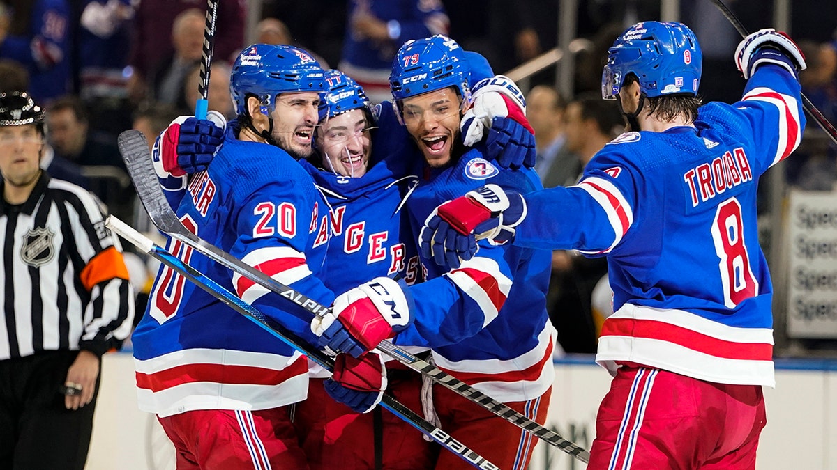 New York Rangers' Chris Kreider (20) celebrates with teammates K'Andre Miller (79) and Jacob Trouba (8) after scoring a goal during the second period of Game 2 of an NHL hockey Stanley Cup first-round playoff series against the Pittsburgh Penguins, Thursday, May 5, 2022, in New York.