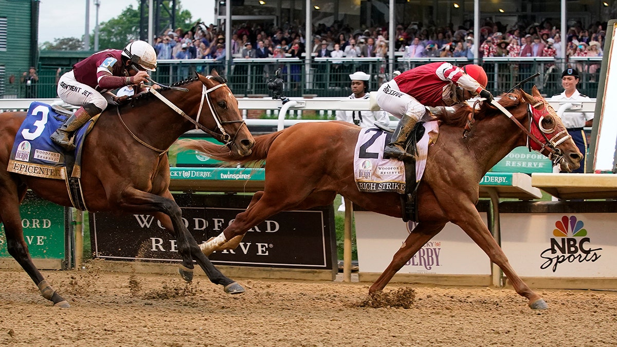 Rich Strike (21), with Sonny Leon aboard, beats Epicenter (3), with Joel Rosario aboard, at the finish line to win the 148th running of the Kentucky Derby horse race at Churchill Downs Saturday, May 7, 2022, in Louisville, Ky.