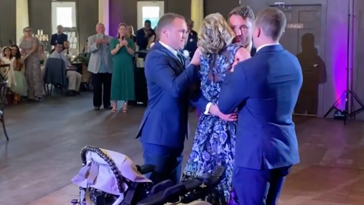 Zak and Kathy Poirer dance at Zak's wedding with help from his brothers, Nick and Jake