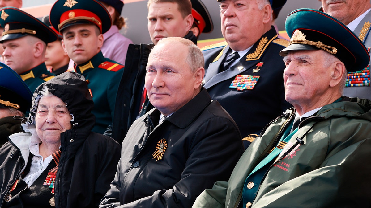 Russian President Vladimir Putin flanked by military officials at Victory Day parade